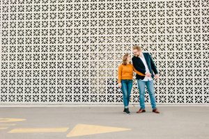 Grand Rapids Engagement photos in front of a fun white wall.