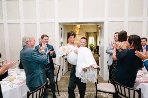 A bride and groom at their grand entrance at their reception at Cascade Hills Country Club in Grand Rapids.