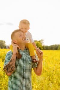 Grand Rapids family photos in a sunflower field photographed by Mae Photo Co.