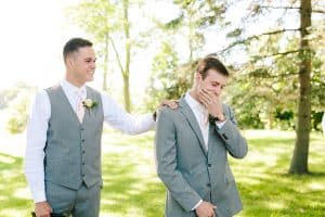 A groom seeing his bride come down the aisle for the first time.