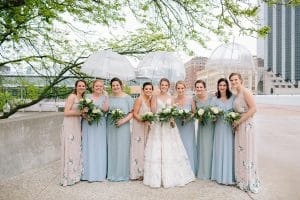 A rainy wedding day in downtown Grand Rapids with mismatched bridesmaids dresses of blues and floral print.