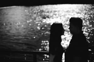 A unique engagement session photo of a silhouette by the Grand River in downtown Grand Rapids.