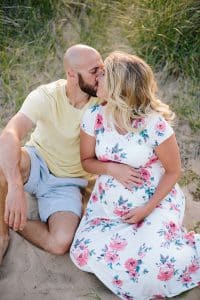 A beach maternity session at sunset at the Holland State Park in Michigan.