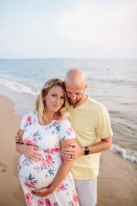 A beach maternity session at sunset at the Holland State Park in Michigan.