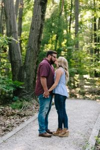 A romantic engagement session in Grand Haven Michigan at Rosy Mounds nature trails with a beautiful couple and beautiful sunlight.