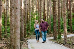 A romantic engagement session in Grand Haven Michigan at Rosy Mounds nature trails with a beautiful couple and beautiful sunlight.