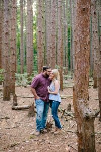 A romantic engagement session in Grand Haven Michigan at Rosy Mounds nature trails with a beautiful couple and beautiful sunlight.