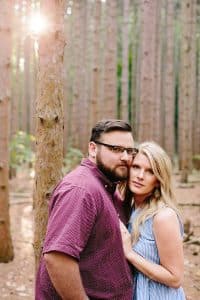 A romantic engagement session in Grand Haven Michigan at Rosy Mounds nature trails with a beautiful couple and beautiful sunlight.