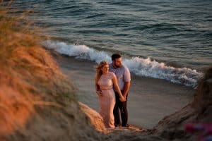 A beach engagement session in Grand Haven at Rosy Mounds.