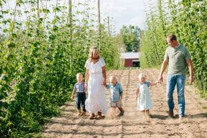 Michigan family lifestyle photography in a hop yard with the most adorable triplets. Great kids outfit ideas and a unique picture location idea.