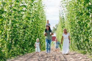 Michigan family lifestyle photography in a hop yard with the most adorable triplets. Great kids outfit ideas and a unique picture location idea.