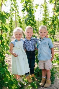 Michigan family lifestyle photography in a hop yard with the most adorable triplets. Great kids outfit ideas and a unique picture location idea.