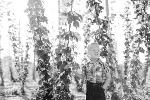 Michigan family lifestyle photography in a hop yard with the most adorable triplets. Great kids outfit ideas and a unique picture location idea.