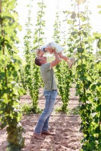 Michigan family lifestyle photography in a hop yard with the most adorable triplets. Great kids outfit ideas and a unique picture location idea.