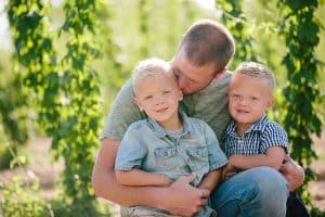 Michigan family lifestyle photography in a hop yard with the most adorable triplets. Great kids outfit ideas and a unique picture location idea.