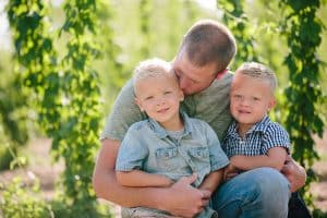 Michigan family lifestyle photography in a hop yard with the most adorable triplets. Great kids outfit ideas and a unique picture location idea.