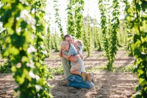 Michigan family lifestyle photography in a hop yard with the most adorable triplets. Great kids outfit ideas and a unique picture location idea.