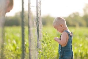 A day in the life photography session at the families farmhouse in Michigan with triplets, adorable kids fashion, goats, chickens, and fresh vegetables.