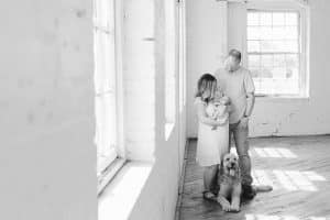 A newborn lifestyle session in a photography studio in Grand Rapids with a dog.