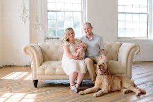 A newborn lifestyle session in a photography studio in Grand Rapids with a dog.