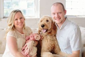 A newborn lifestyle session in a photography studio in Grand Rapids with a dog.