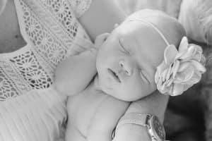 A newborn lifestyle session in a photography studio in Grand Rapids with a dog.