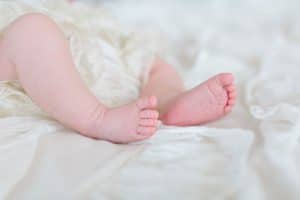 A newborn lifestyle session in a photography studio in Grand Rapids with a dog.