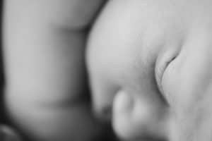 A newborn lifestyle session in a photography studio in Grand Rapids with a dog.