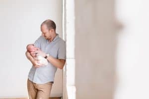 A newborn lifestyle session in a photography studio in Grand Rapids with a dog.