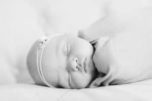 A newborn lifestyle session in a photography studio in Grand Rapids with a dog.