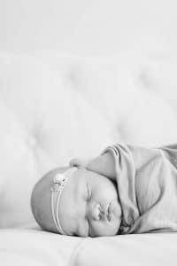 A newborn lifestyle session in a photography studio in Grand Rapids with a dog.