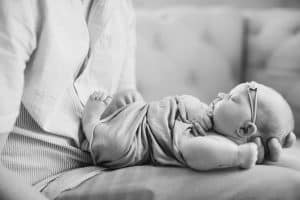 A newborn lifestyle session in a photography studio in Grand Rapids with a dog.