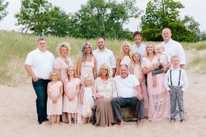 A Michigan Holland beach family engagement with a white, pink, and light blue color pallet.