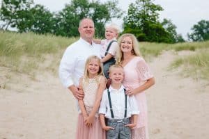 A Michigan Holland beach family engagement with a white, pink, and light blue color pallet.