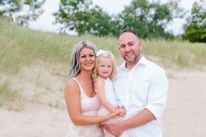 A Michigan Holland beach family engagement with a white, pink, and light blue color pallet.