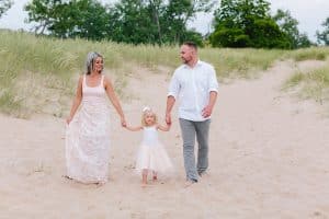 A Michigan Holland beach family engagement with a white, pink, and light blue color pallet.