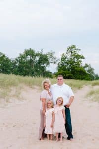 A Michigan Holland beach family engagement with a white, pink, and light blue color pallet.