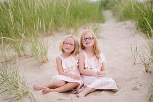 A Michigan Holland beach family engagement with a white, pink, and light blue color pallet.