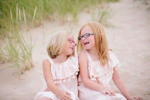 A Michigan Holland beach family engagement with a white, pink, and light blue color pallet.