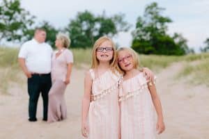 A Michigan Holland beach family engagement with a white, pink, and light blue color pallet.