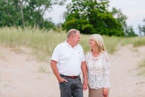 A Michigan Holland beach family engagement with a white, pink, and light blue color pallet.