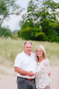 A Michigan Holland beach family engagement with a white, pink, and light blue color pallet.