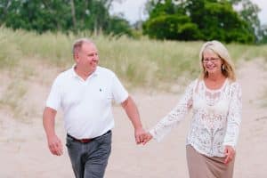 A Michigan Holland beach family engagement with a white, pink, and light blue color pallet.