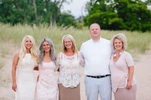 A Michigan Holland beach family engagement with a white, pink, and light blue color pallet.