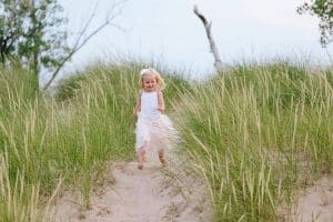 A Michigan Holland beach family engagement with a white, pink, and light blue color pallet.