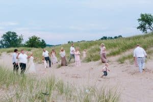 A Michigan Holland beach family engagement with a white, pink, and light blue color pallet.