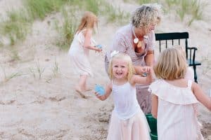 A Michigan Holland beach family engagement with a white, pink, and light blue color pallet.