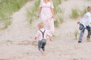 A Michigan Holland beach family engagement with a white, pink, and light blue color pallet.