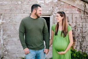 A country lifestyle maternity session right at Jen and Sean's home in Caledonia Michigan. Jen wore a beautiful green dress and their dogs even made an appearance.