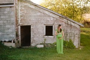 A country lifestyle maternity session right at Jen and Sean's home in Caledonia Michigan. Jen wore a beautiful green dress and their dogs even made an appearance.